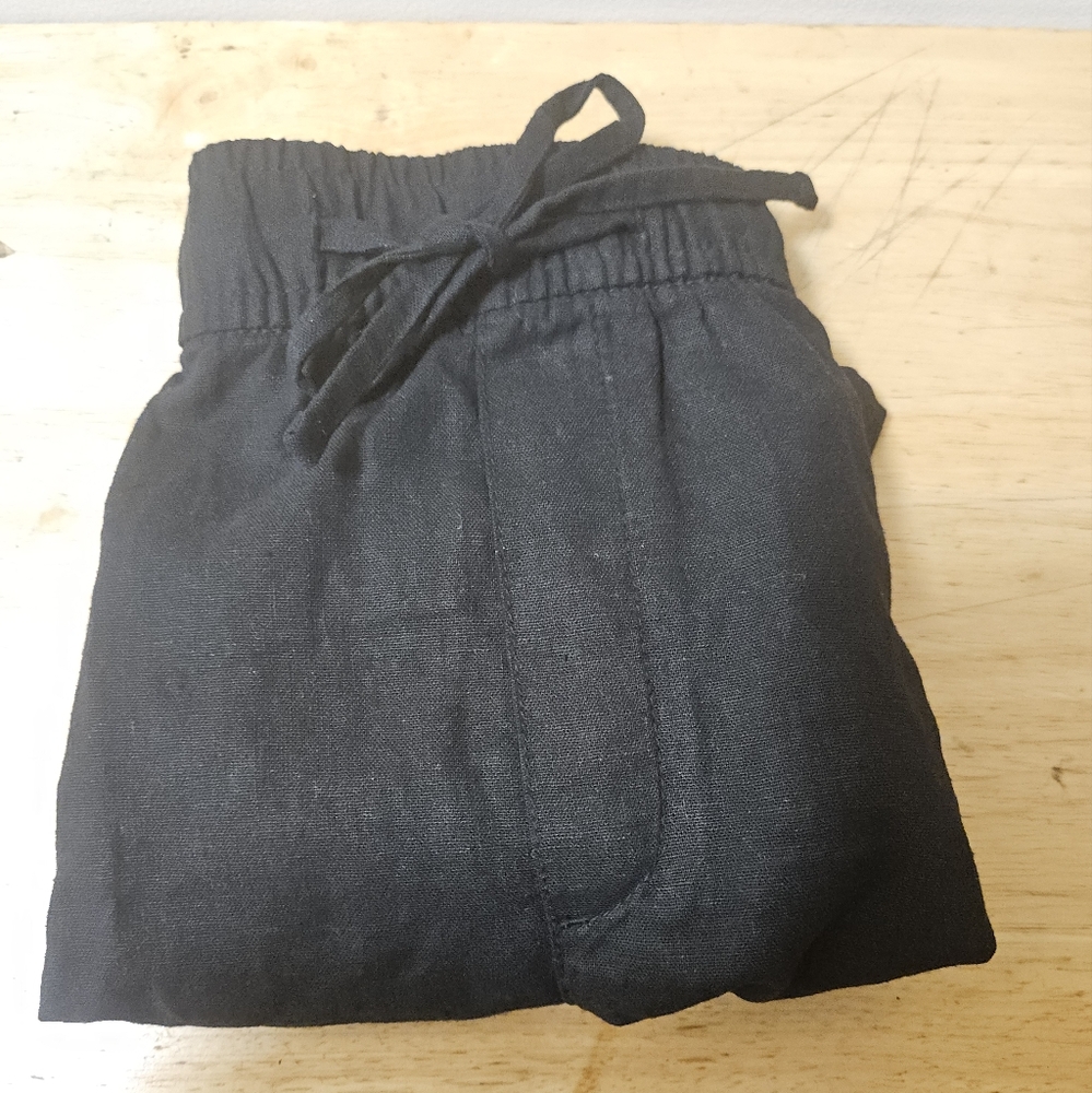 Black Flat Front Shorts with Elastic Waistband and Drawstring.